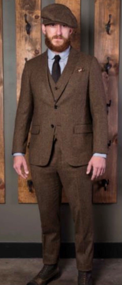 This image has an empty alt attribute; its file name is brownsuit.jpg